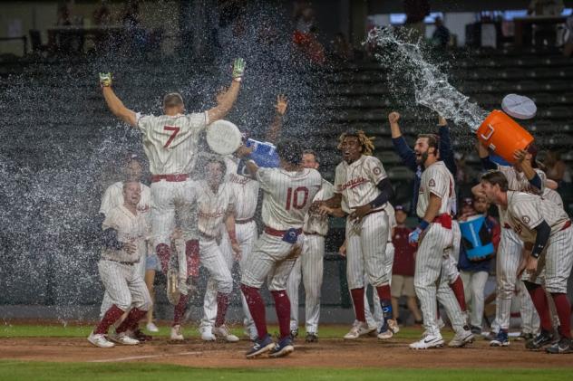 Colin Willis #7 and the Kansas City Monarchs celebrate the walk off win over the Houston Apollos