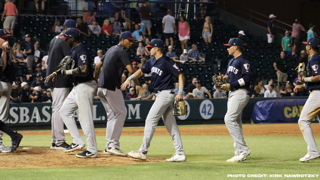 Somerset Patriots exchange high fives following a win