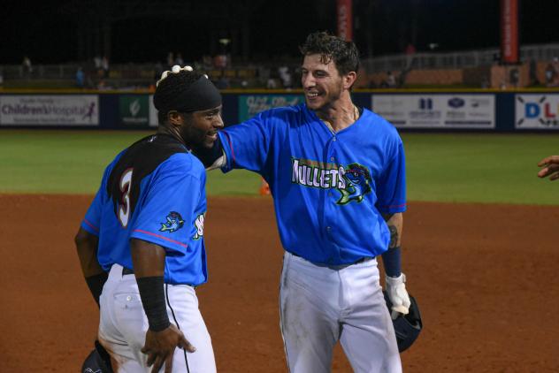 Devin Hairston and Galli Cribbs Jr. (right) of the Pensacola Blue Wahoos after Cribbs' game-winning hit