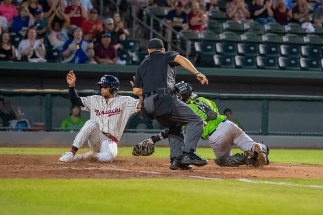 Charcer Burks of the Kansas City Monarchs slides in ahead of the tag of the Kane County Cougars' BJ Lopez