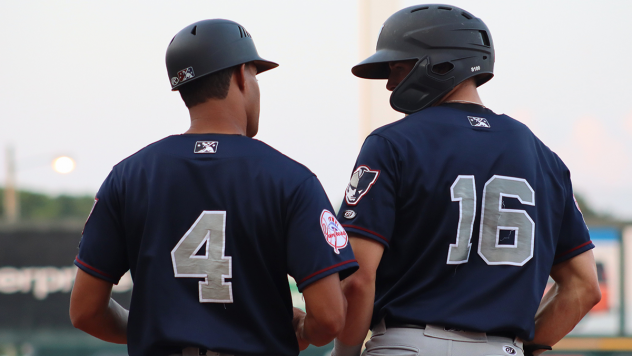 Somerset Patriots coach Jose Javier and outfielder Brandon Lockridge (16)