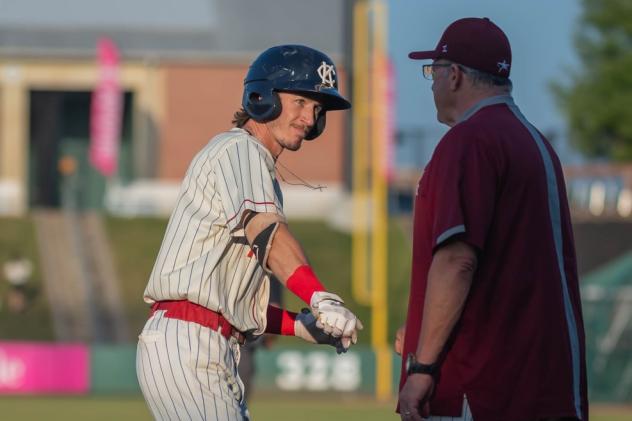 Kansas City Monarchs second baseman Ryan Grotjohn celebrates one of his two RBI against the Houston Apollos with third base coach Bill Sobbe
