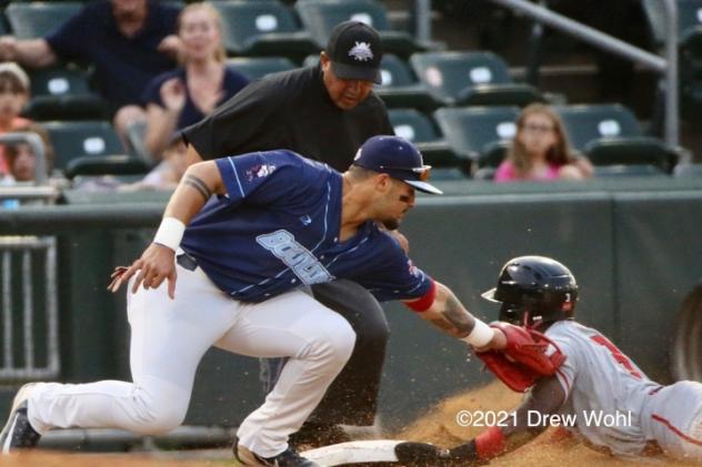 New Jersey Jackals' Demetrius Moorer slides safely into third base on a steal attempt ahead of tag by the New York Boulders' Ray Hernandez