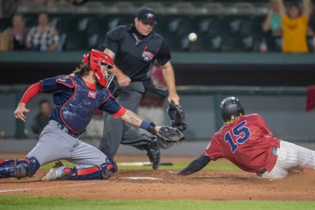 Kansas City Monarchs' Gabby Guerrero slides in ahead of the tag of Cleburne catcher John Nester