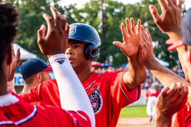 Andrew Pinckney receives congratulations from his St. Cloud Rox teammates