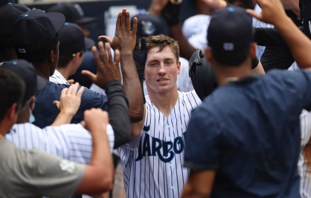 Cooper Bowman receives congratulations from his Tampa Tarpons teammates following his grand slam