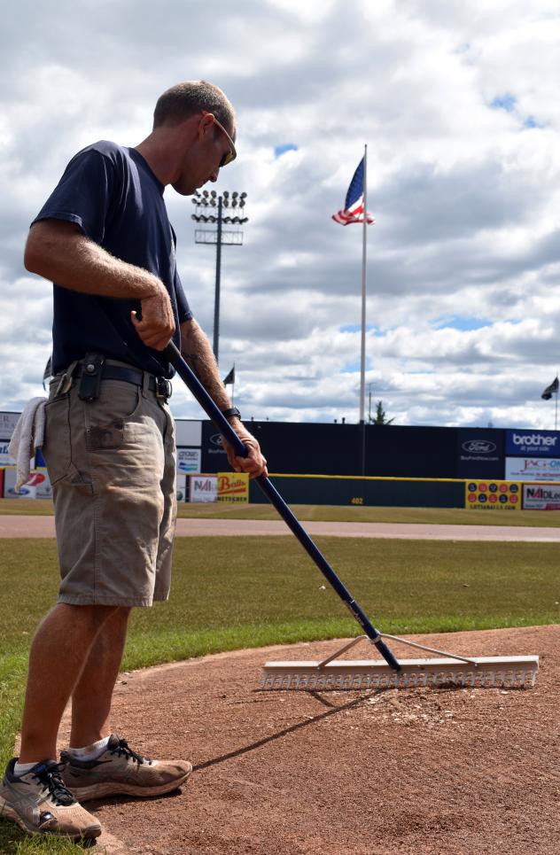 Somerset Patriots Head Groundskeeper Dan Purner works on the field the day after the flooding