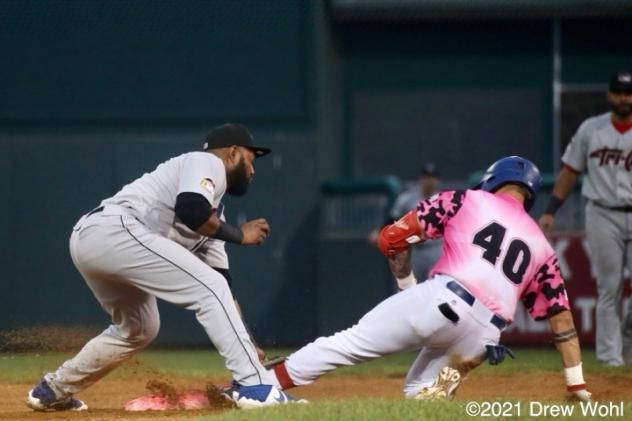 New York Boulders' Ray Hernandez slides safely into second base with a double under the tag of Tri-City SS Juan Silverio