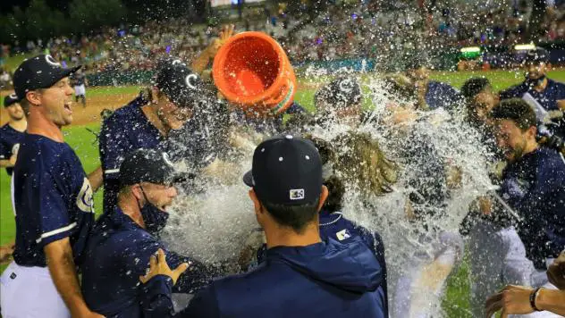 Kane County Cougars celebrate after a walk-off victory on August 7