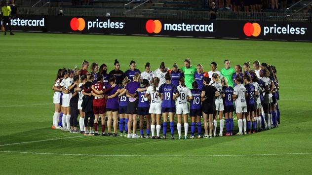 Racing Louisville FC and North Carolina Courage gather at midfield