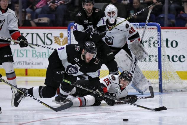 Reading Royals forward Brayden Low (left) eyes a loose puck