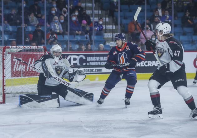Vancouver Giants goaltender Will Gurski tries to fend off the Kamloops Blazers