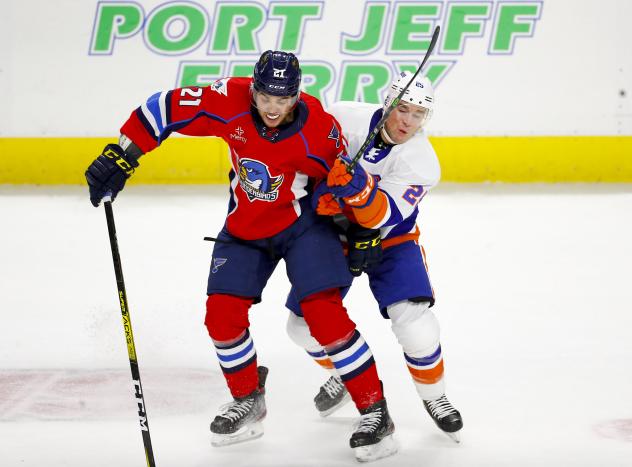 Springfield Thunderbirds left wing Nolan Stevens (left) takes on the Bridgeport Islanders