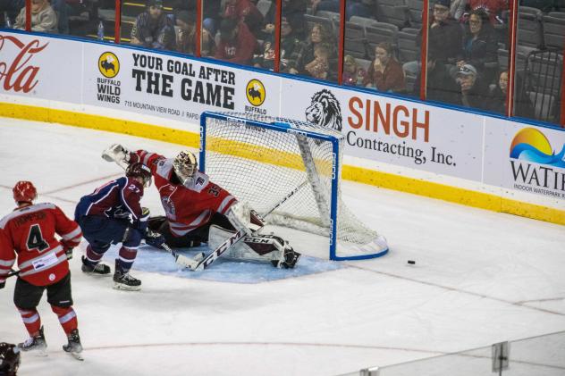 Rapid City Rush goaltender David Tendeck turns aside a Tulsa Oilers shot