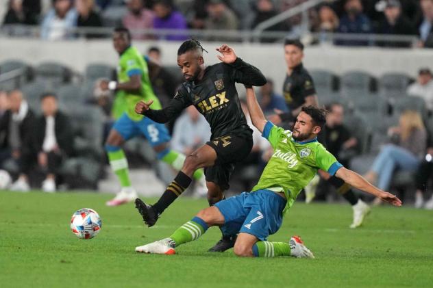 Seattle Sounders FC midfielder Cristian Roldan slides to make a tackle at LAFC