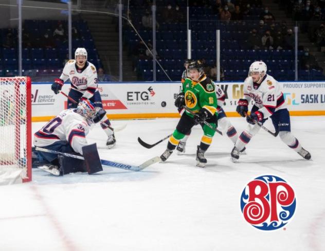 Swift Current Broncos left wing Brady Birnie (center) vs. the Regina Pats