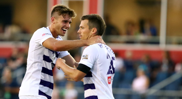Antoine Hoppenot (right) receives congratulations after scoring the winning goal for Louisville City FC