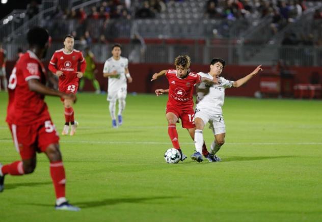 Phoenix Rising FC forward Arturo Rodriguez takes the ball from Tacoma Defiance