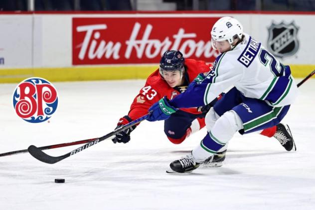 Swift Current Broncos defenceman Ryan Bettahar (right) reaches for the puck vs. the Regina Pats