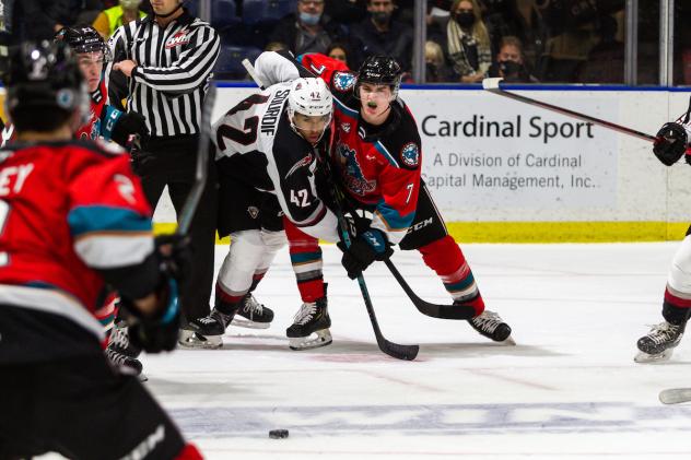 Vancouver Giants centre Justin Sourdif (left) faces off with the Kelowna Rockets