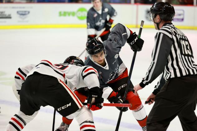 Vancouver Giants centre Ty Halaburda (center) faces off with the Portland Winterhawks