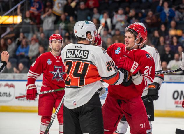 Allen Americans defenseman Jay Jerome (right) exchanges greetings with the Kansas City Mavericks