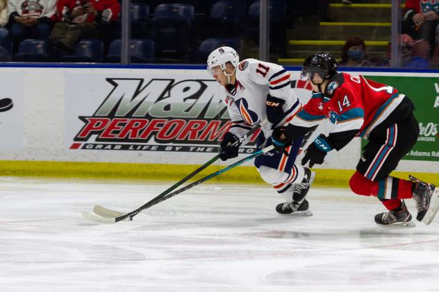 Kelowna Rockets defenceman Elias Carmichael (right) in chase against the Kamloops Blazers