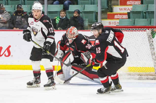 Vancouver Giants left wing Adam Hall set up in front of the Prince George Cougars net