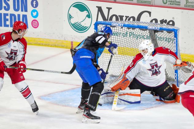 Allen Americans try to stop Jay Dickman of the Wichita Thunder from scoring