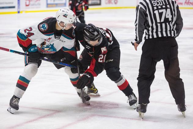Kelowna Rockets centre Dylan Wightman (left) faces off with the Prince George Cougars