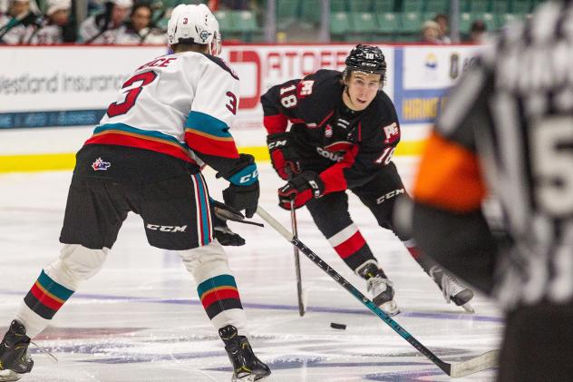 Prince George Cougars left wing Jonny Hooker (right) vs. the Kelowna Rockets