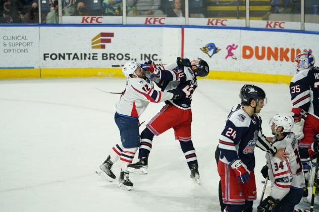 Springfield Thunderbirds left wing Nathan Walker (left) delivers a blow against the Hartford Wolf Pack