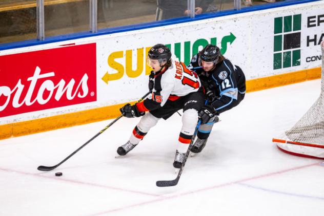 Medicine Hat Tigers defenceman Dru Krebs (left) vs. the Winnipeg ICE