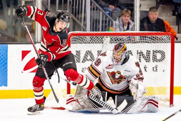 Red Deer Rebels centre Kalan Lind vs. the Calgary Hitmen goaltender