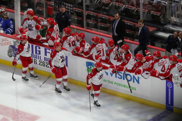 Allen Americans exchange high fives along the bench after a goal against the Wichita Thunder