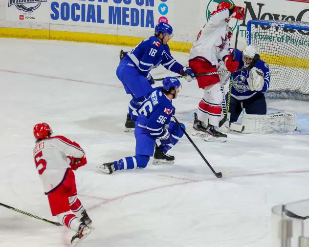 Gavin Gould of the Allen Americans (lower left) shoots through traffic against the Wichita Thunder