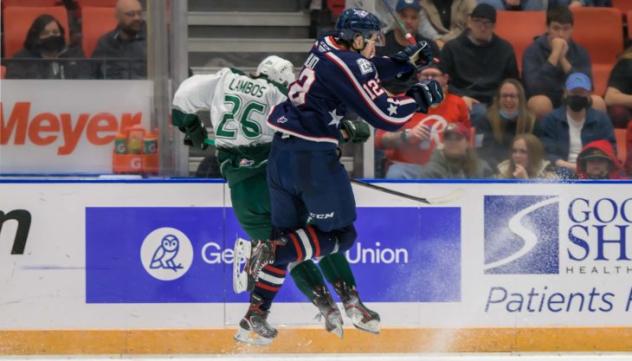 Tri-City Americans center Samuel Huo delivers a blow against the Everett Silvertips