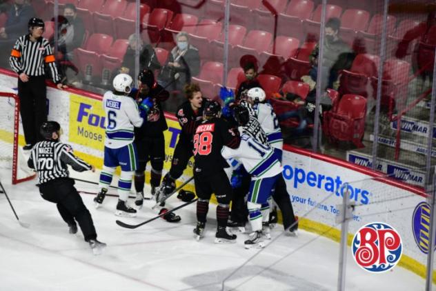 Swift Current Broncos fight with the Moose Jaw Warriors