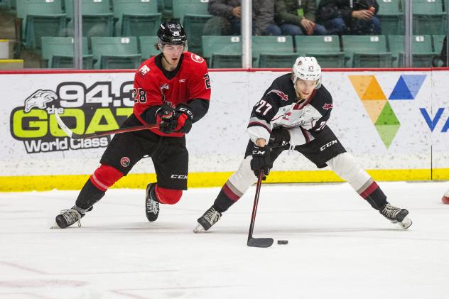 Vancouver Giants defenceman Alex Cotton (right) vs. the Prince George Cougars