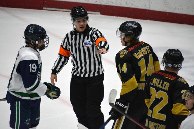 North Iowa Bulls forward Michael Mesic (left) and Bismarck Bobcats defenseman Aiden VanRooyan