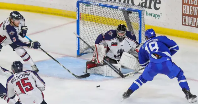 Wichita Thunder forward Carter Johnson (right) vs. the Tulsa Oilers