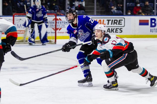 Kelowna Rockets centre Colton Dach (right) battles the Victoria Royals