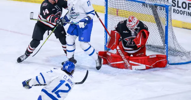 Cam Clarke of the Wichita Thunder (bottom) takes a shot against the Rapid City Rush