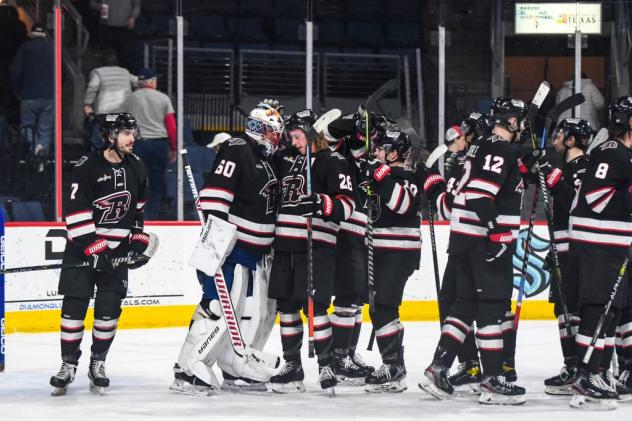 Rapid City Rush exchange congratulations after a win against the Allen Americans