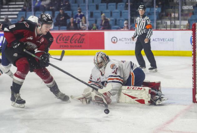 Vancouver Giants left wing Zach Ostapchuk (left) vs. the Kamloops Blazers