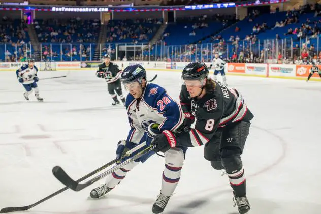 Rapid City Rush defenseman Kenton Helgeson (right) vs. the Tulsa Oilers