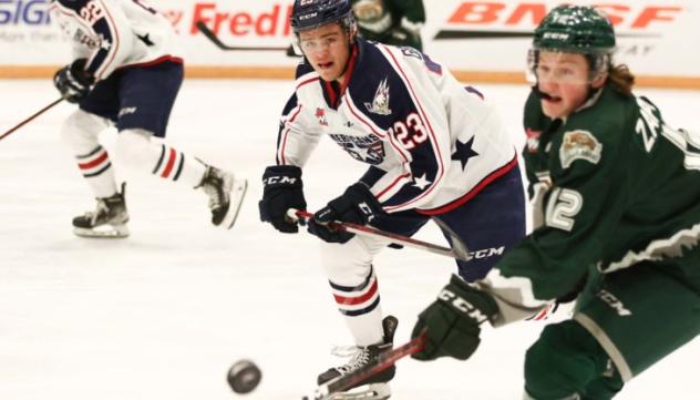 Tri-City Americans and Everett Silvertips pursue the puck