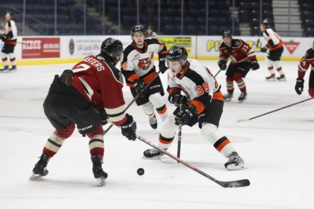 Medicine Hat Tigers left wing Brendan Lee (right) vs. the Red Deer Rebels