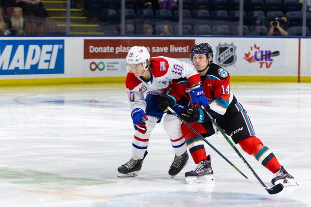 Kelowna Rockets defenseman Elias Carmichael (right) vs. the Spokane Chiefs