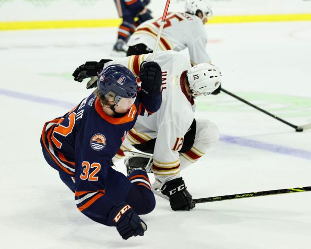 Vancouver Giants left wing Adam Hall gets tripped up by the Kamloops Blazers